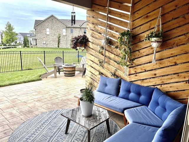 view of patio featuring an outdoor living space with a fire pit