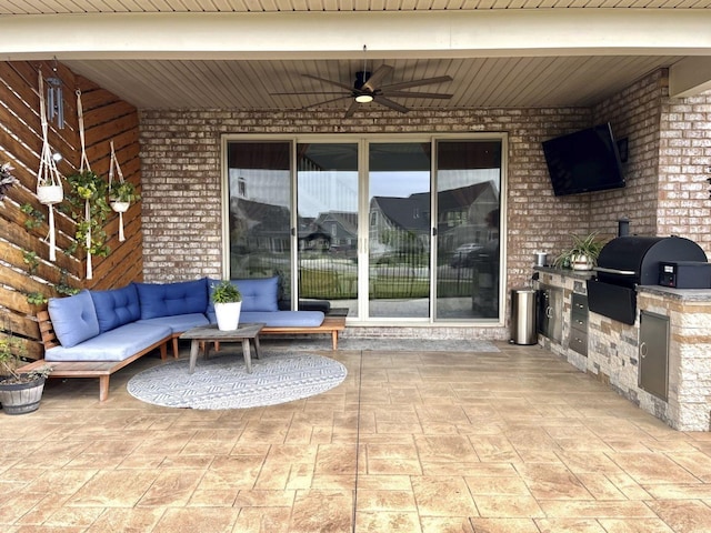 view of patio / terrace featuring ceiling fan, an outdoor kitchen, an outdoor hangout area, and area for grilling