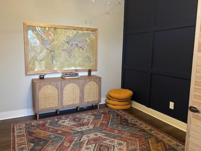 sitting room with dark hardwood / wood-style flooring