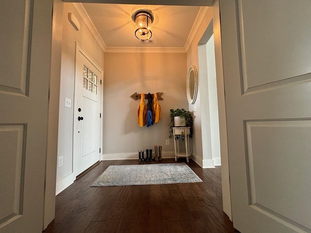 entrance foyer featuring ornamental molding and dark hardwood / wood-style flooring