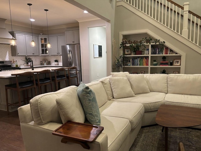 living room featuring ornamental molding and dark hardwood / wood-style floors