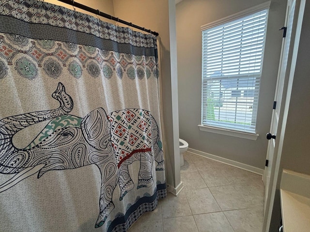 bathroom with tile patterned floors and toilet