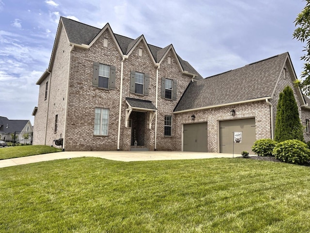 view of front of home featuring a garage and a front yard