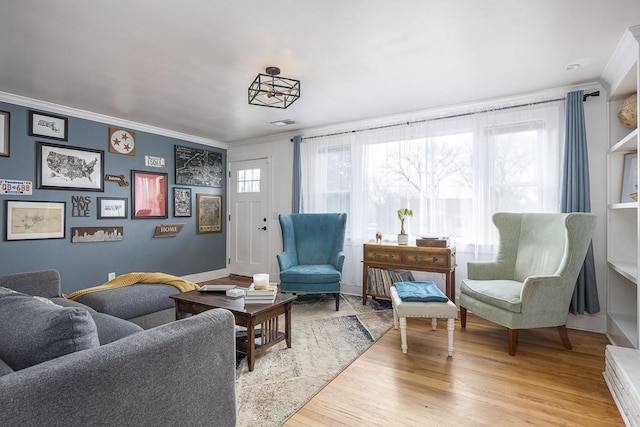 interior space featuring ornamental molding and light hardwood / wood-style floors