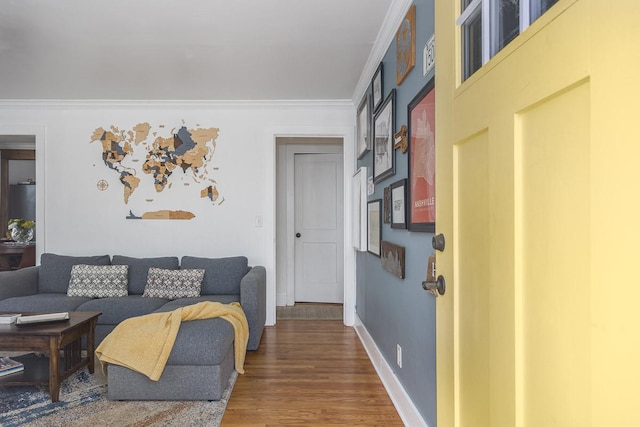 living room featuring hardwood / wood-style flooring and crown molding