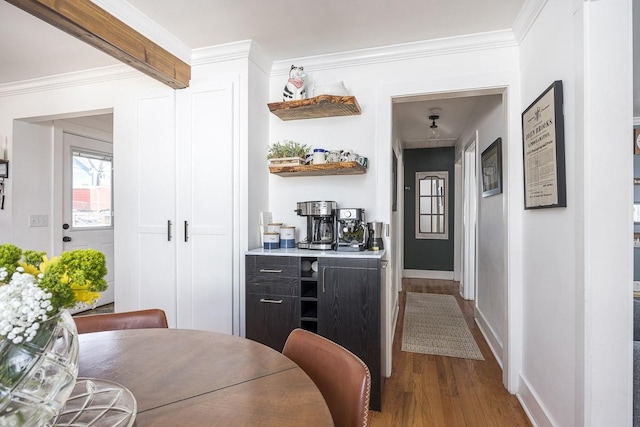 bar featuring crown molding and wood-type flooring