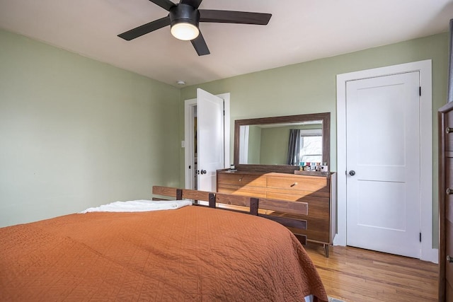 bedroom with light hardwood / wood-style flooring and ceiling fan