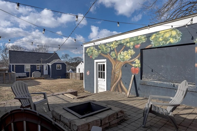 view of patio / terrace featuring an outbuilding and a fire pit