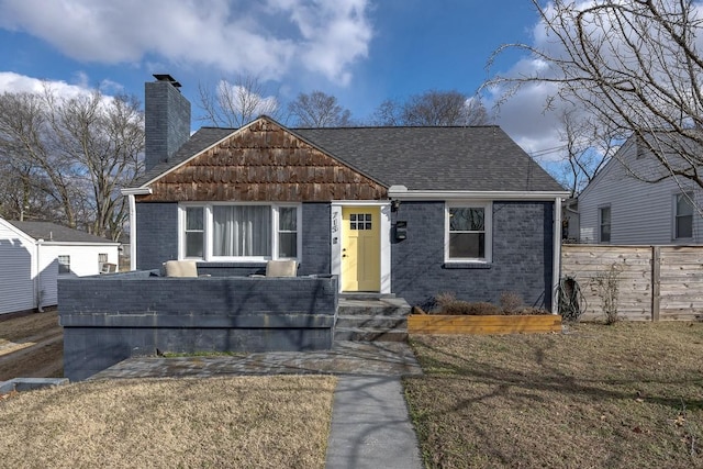 bungalow-style home featuring a front yard