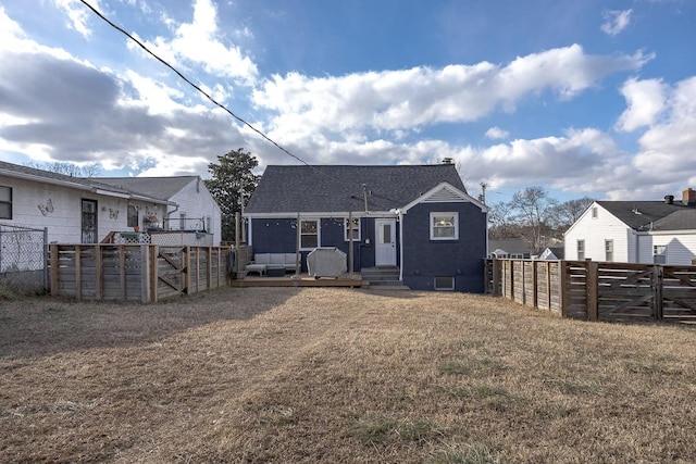 rear view of house featuring a yard