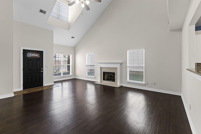 unfurnished living room with ceiling fan, high vaulted ceiling, dark hardwood / wood-style floors, and a fireplace