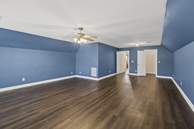 additional living space featuring vaulted ceiling, dark hardwood / wood-style floors, and ceiling fan