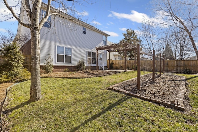 rear view of property featuring a yard and a pergola