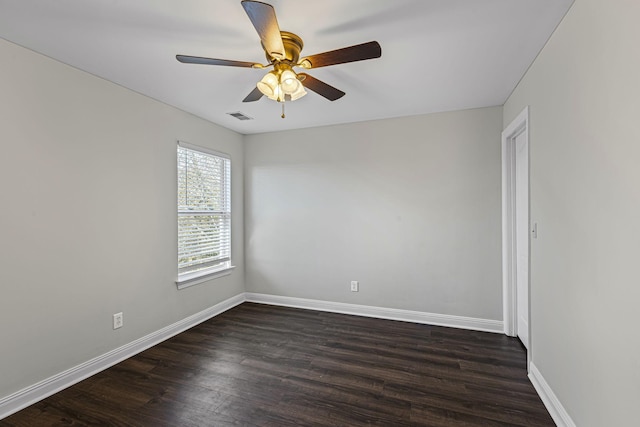 spare room featuring dark wood-type flooring and ceiling fan