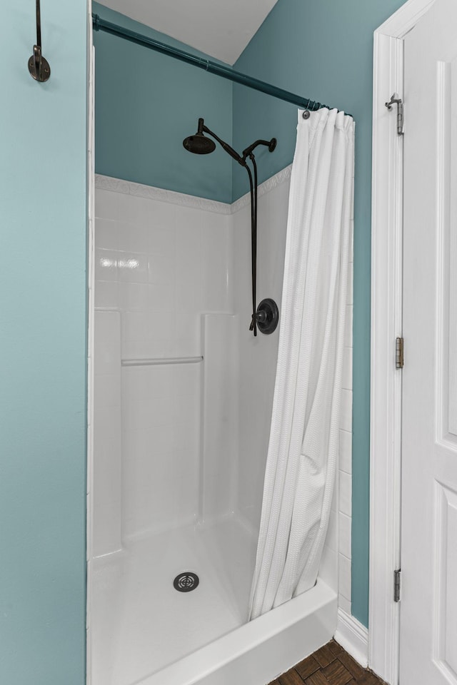 bathroom featuring parquet flooring and curtained shower