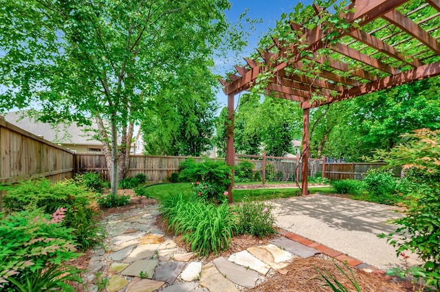 view of yard featuring a patio, a fenced backyard, and a pergola