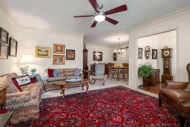 carpeted living room with ceiling fan with notable chandelier and ornamental molding