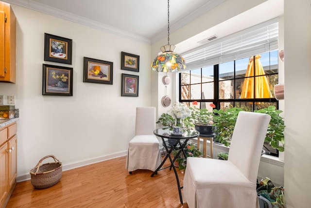 living area with ornamental molding and light wood-type flooring