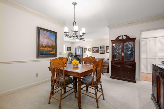 carpeted dining room with a notable chandelier and ornamental molding