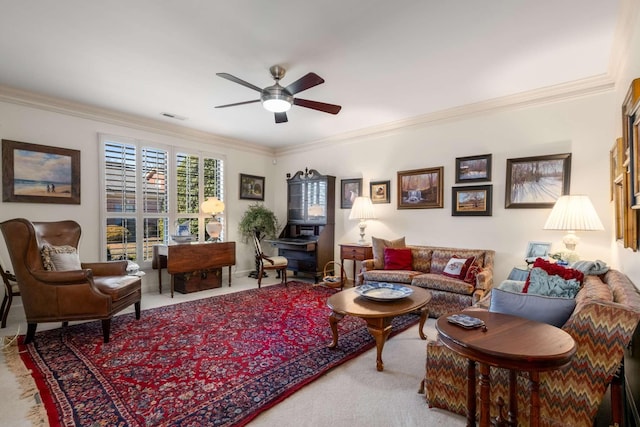 living room featuring ceiling fan, ornamental molding, and carpet flooring