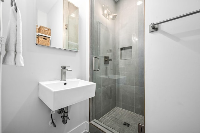 bathroom featuring a shower with door