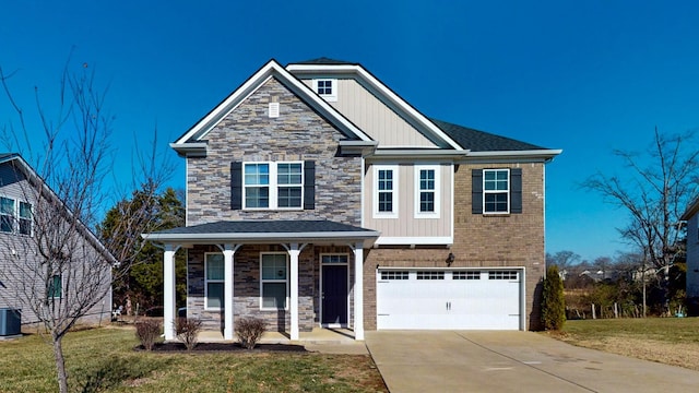 craftsman house with a garage, covered porch, and a front yard