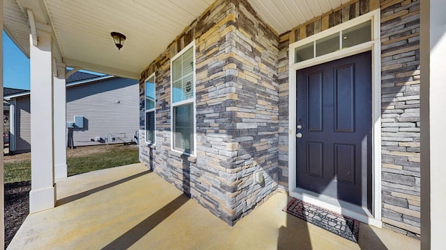 view of exterior entry featuring a porch