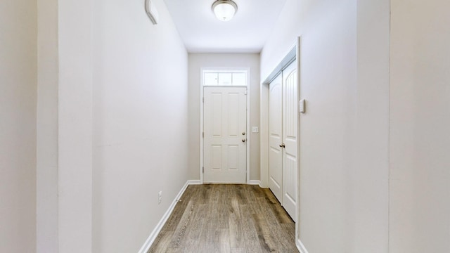 corridor with hardwood / wood-style floors