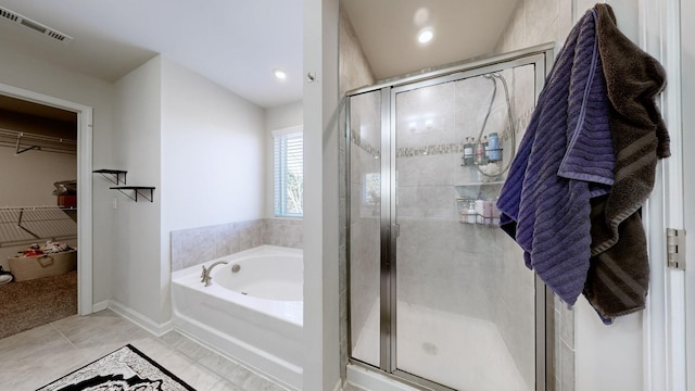 bathroom with tile patterned flooring and separate shower and tub