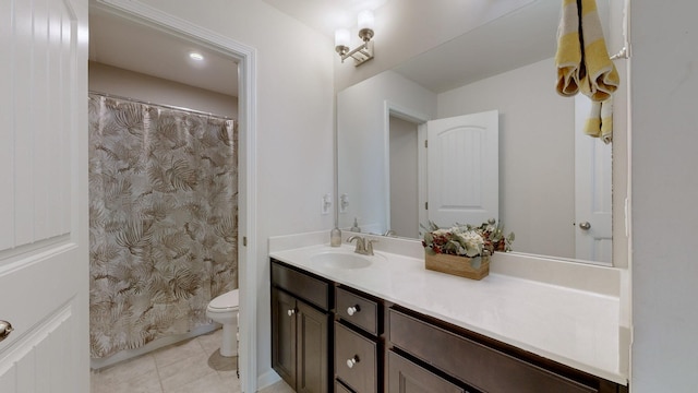 bathroom featuring vanity, toilet, and tile patterned flooring