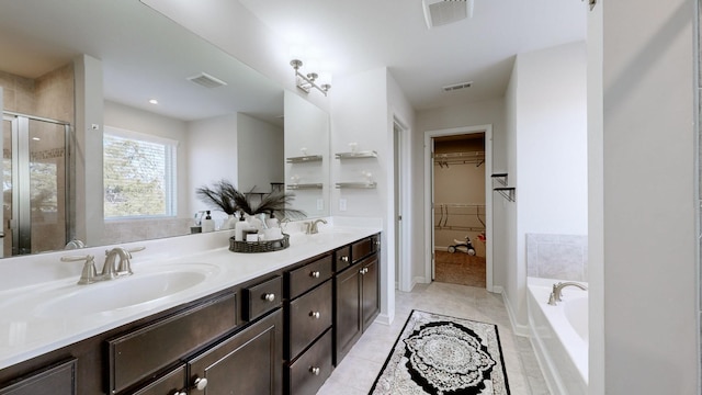 bathroom with vanity, tile patterned flooring, and plus walk in shower