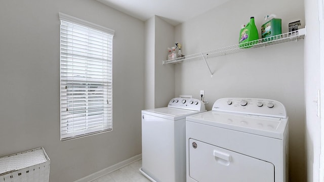 washroom featuring a wealth of natural light and washer and clothes dryer