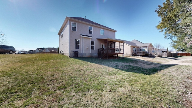 back of house with a lawn