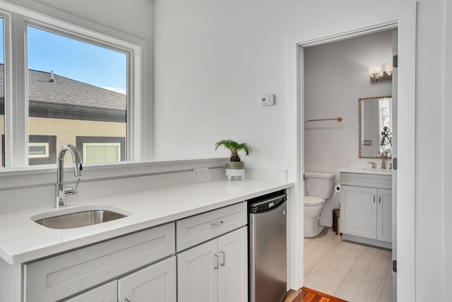 kitchen with refrigerator, sink, and white cabinets