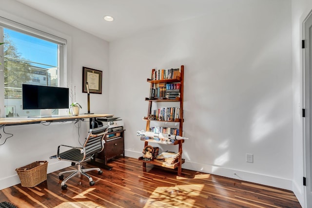 home office with dark wood-type flooring