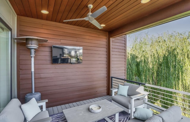 balcony featuring an outdoor living space and ceiling fan