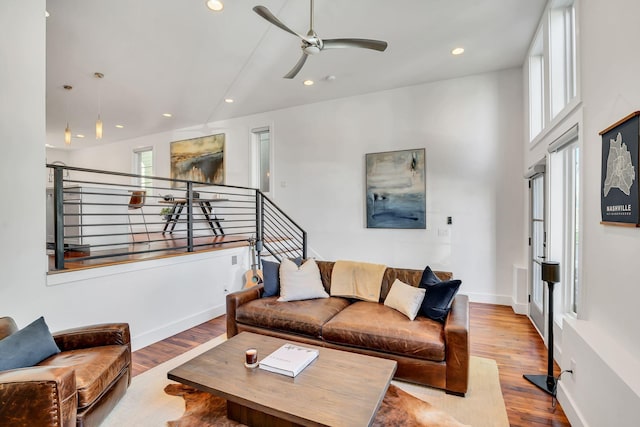 living room with ceiling fan and light wood-type flooring