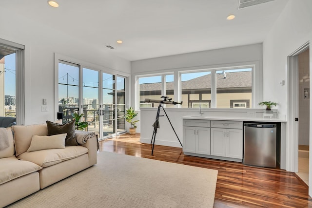 living room with hardwood / wood-style flooring and sink