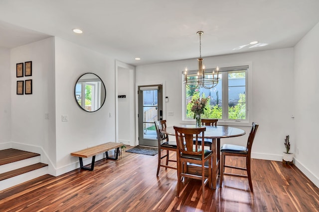 dining area with an inviting chandelier and dark wood-type flooring