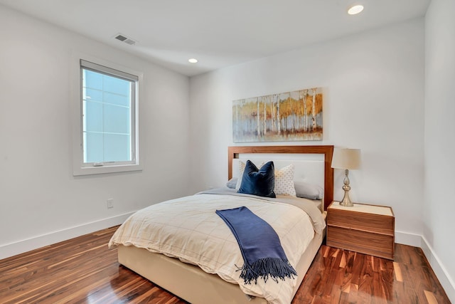 bedroom with dark wood-type flooring