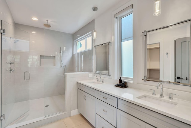 bathroom featuring vanity, tile patterned flooring, and walk in shower