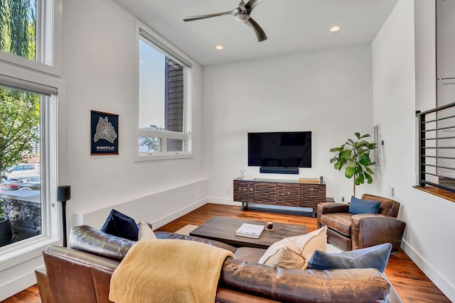 living room with ceiling fan and light wood-type flooring