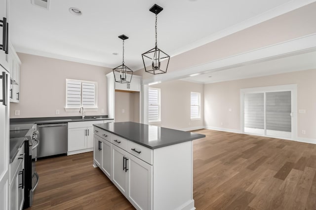 kitchen featuring dark hardwood / wood-style floors, a kitchen island, pendant lighting, stainless steel appliances, and white cabinets