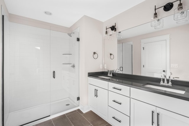 bathroom with a shower with door and vanity