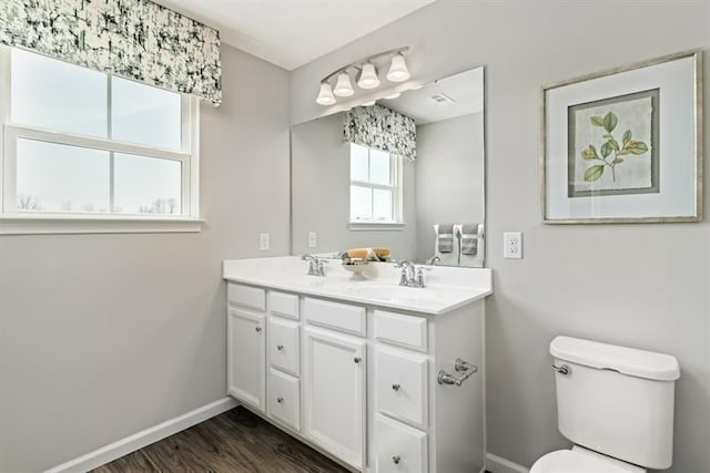 bathroom featuring vanity, hardwood / wood-style floors, and toilet