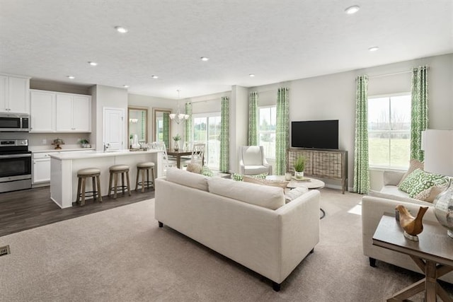 living room with hardwood / wood-style flooring and a chandelier