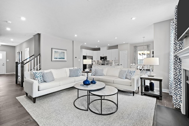 living room featuring an inviting chandelier and dark hardwood / wood-style floors