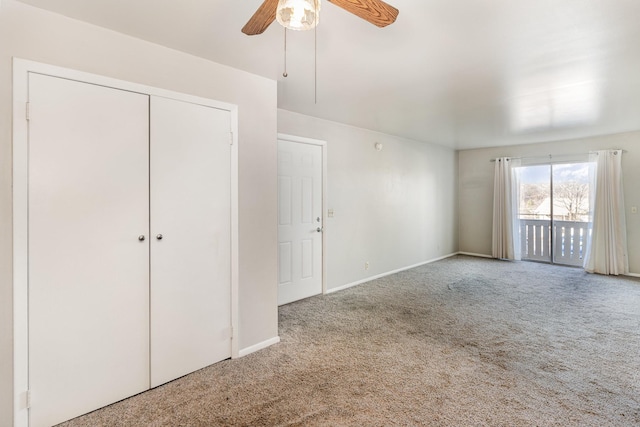 interior space featuring carpet flooring and ceiling fan