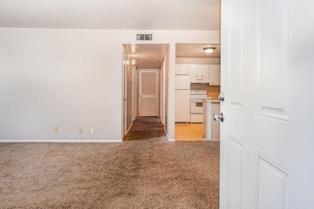 unfurnished room featuring light carpet