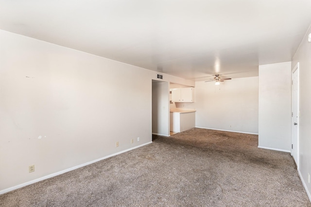 unfurnished living room with ceiling fan and carpet flooring